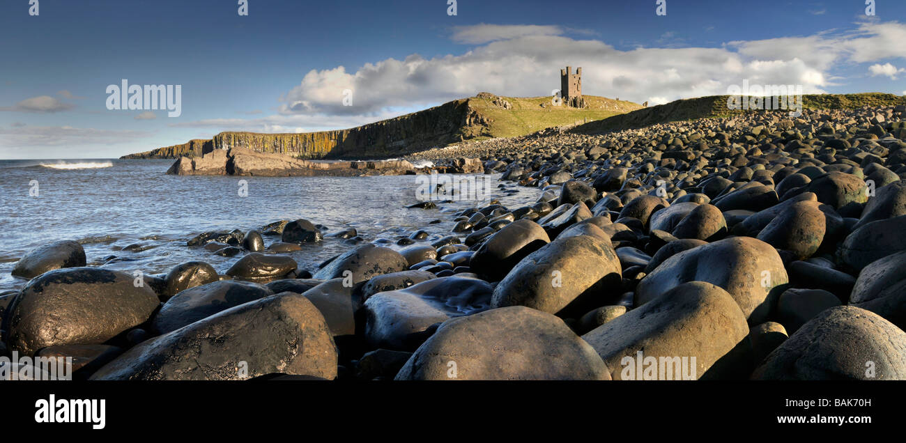 Dolerite Boulders Beneath the Ruined Lilburn Tower at Dunstanburgh Castle, Northumberland, England, UK Stock Photo