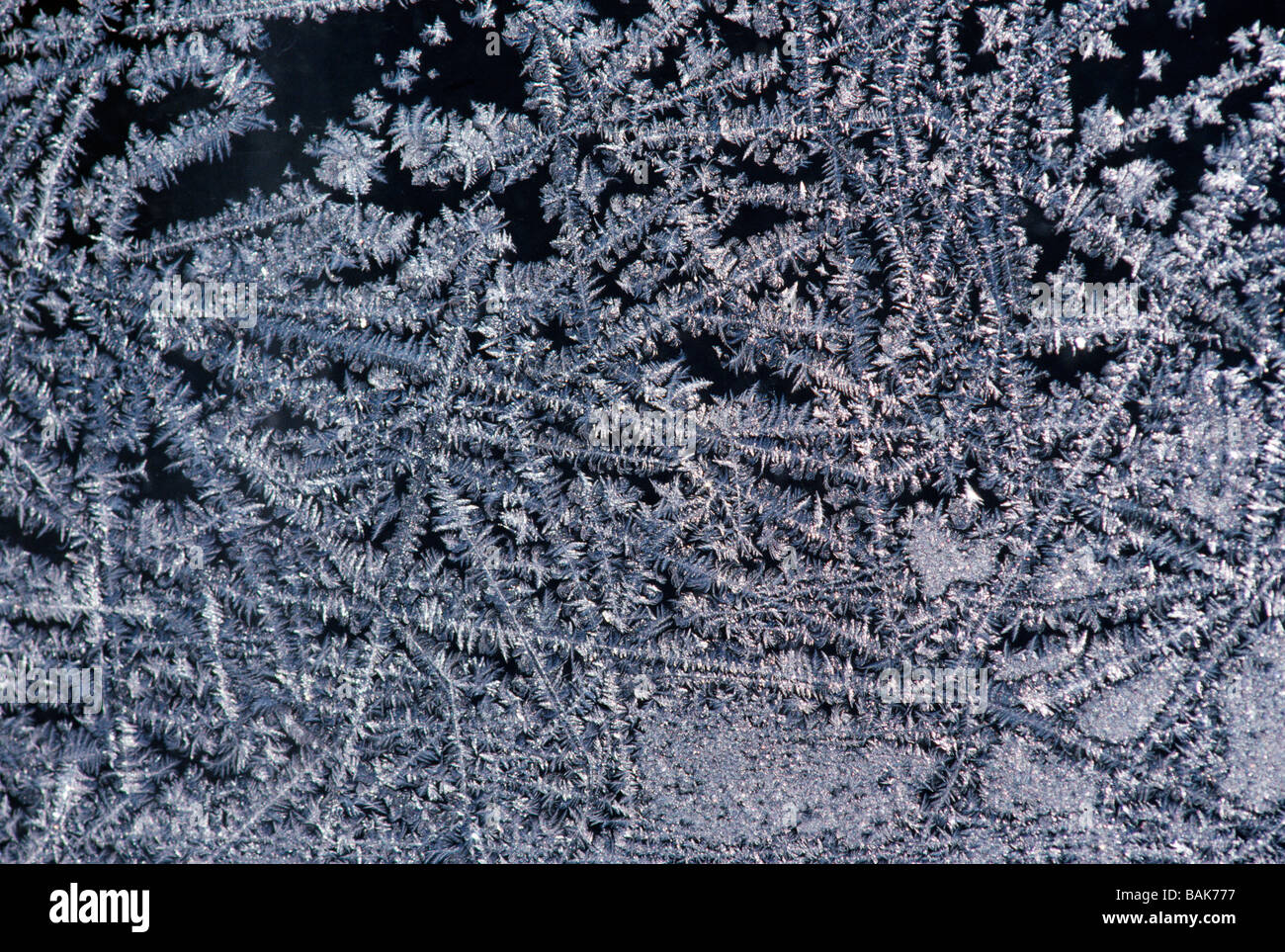 Frost crystals form patterns on a window pane Stock Photo - Alamy