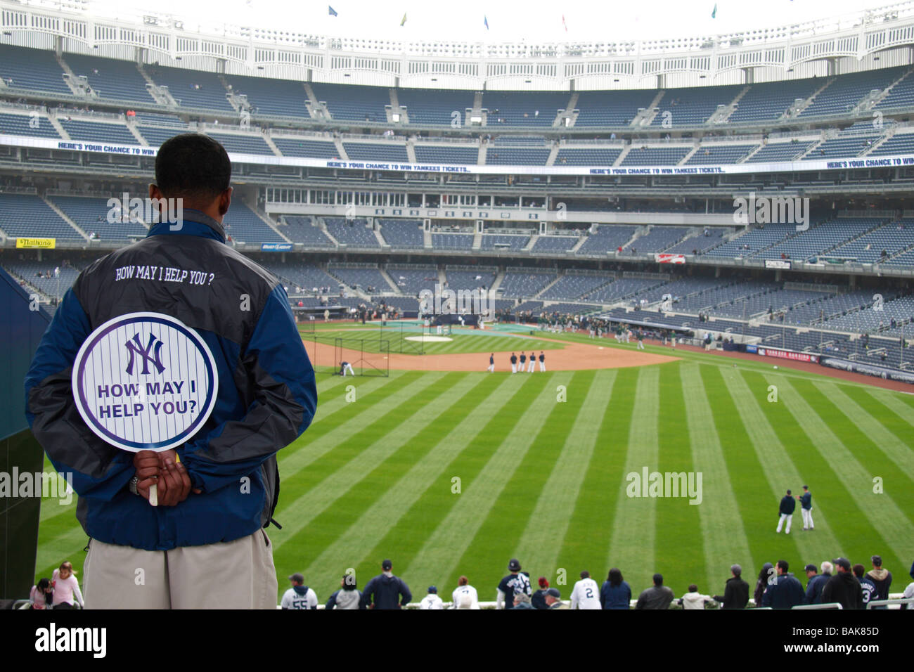 A worker looking out at the outfield during batting practice at the new