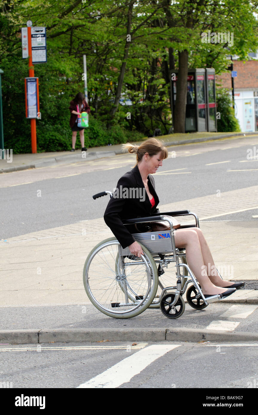 Female sitting in a self propel wheelchair travelling along the