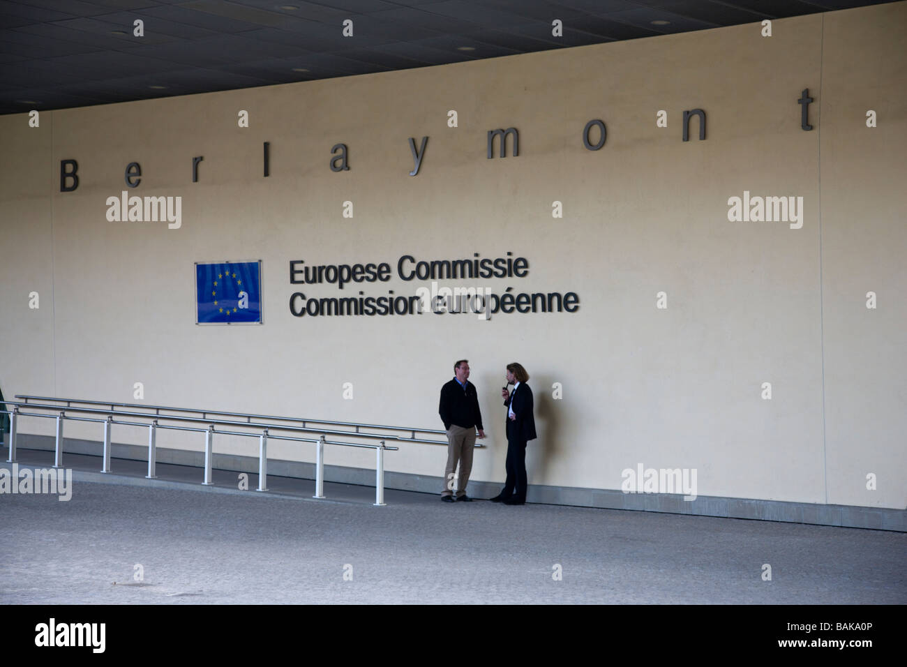Two men in conversation in the shelter of buildings of the European Commission in Brussels Belgium Stock Photo