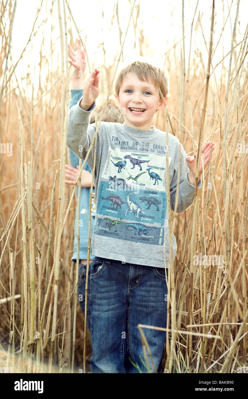 A happy smiling boy in long reeds Stock Photo