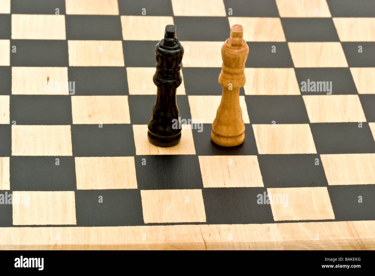 Two chess piece kings facing off on chess board Stock Photo