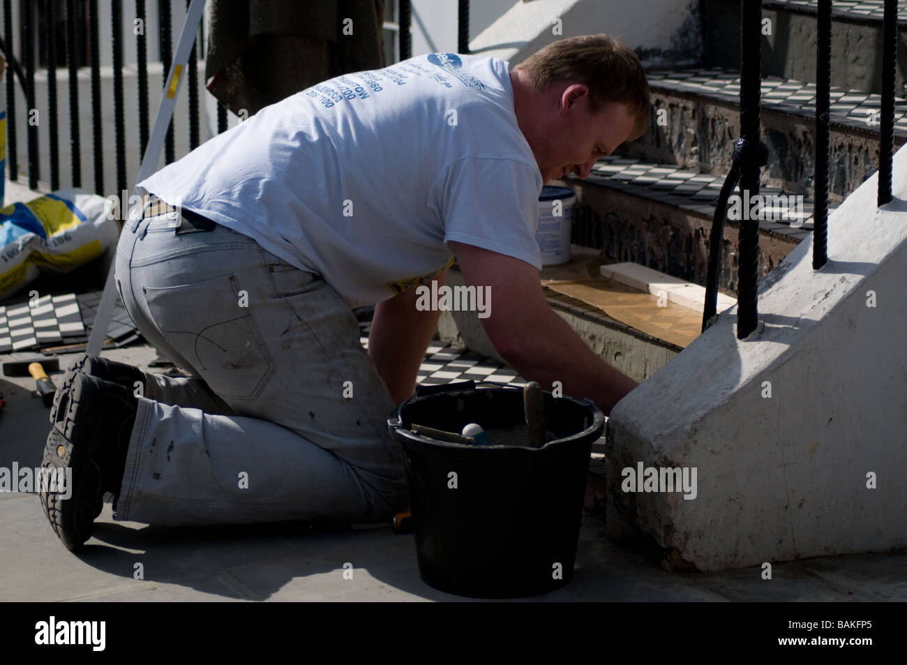 Man working outside house stairs hires stock photography and images