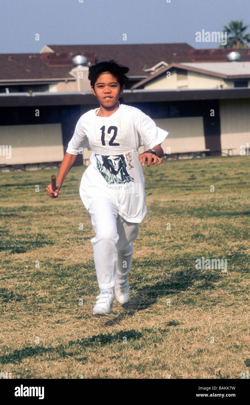 FilapinaAmerican girl run track baton race fast effort school grass