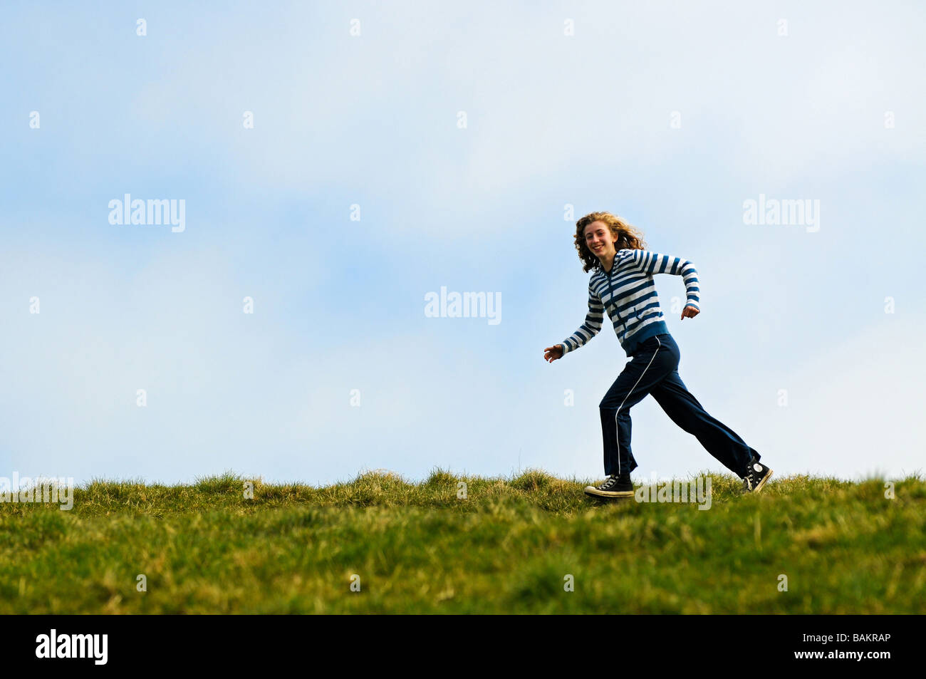 action shot of girl jogging outdoors Stock Photo