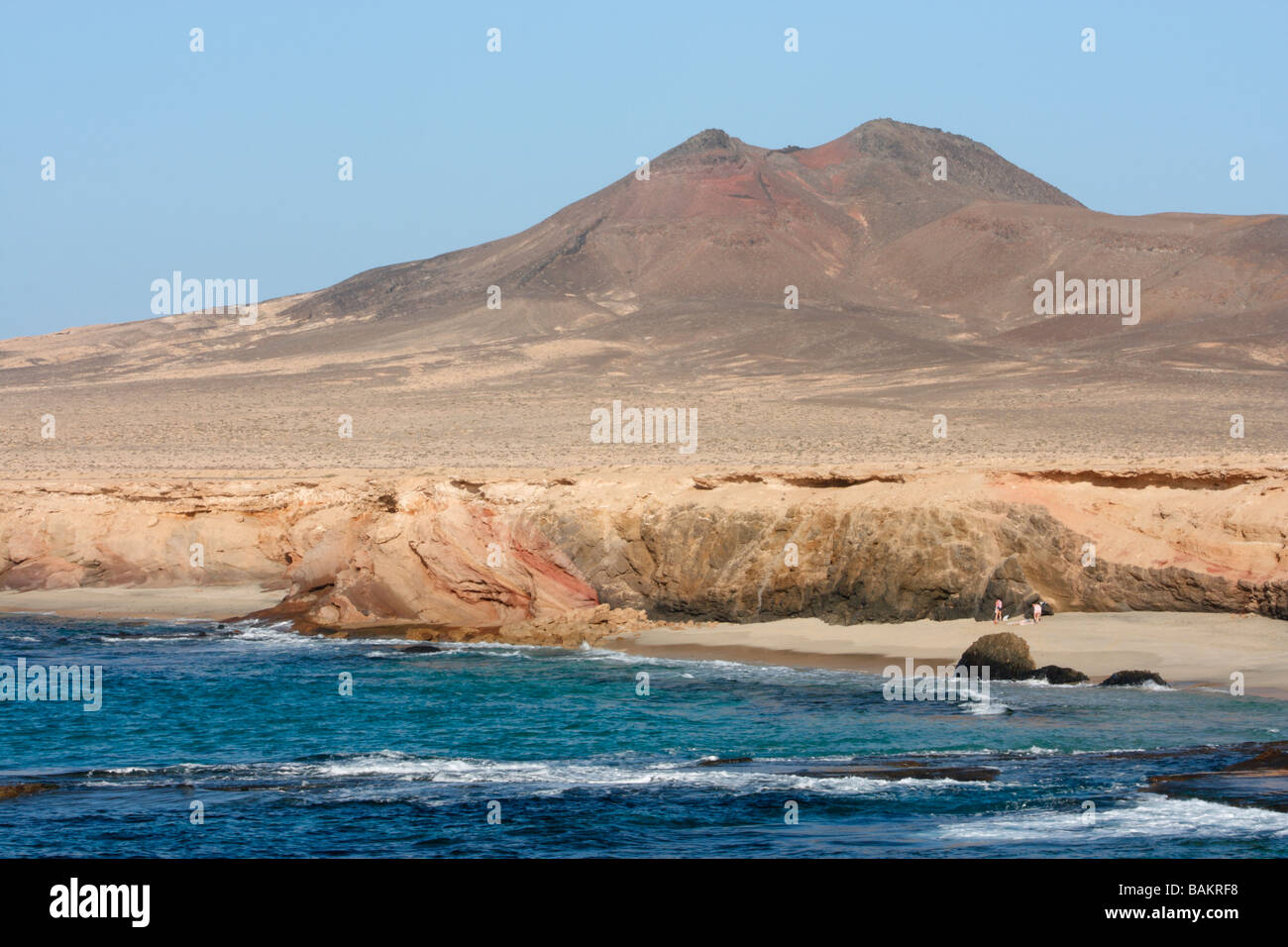 Couple on empty beach on southern tip of Fuerteventura in the Canary islands Stock Photo