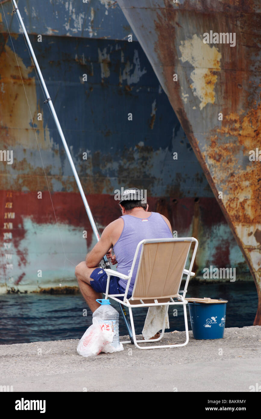 Man fishing on dock in Spain Stock Photo - Alamy