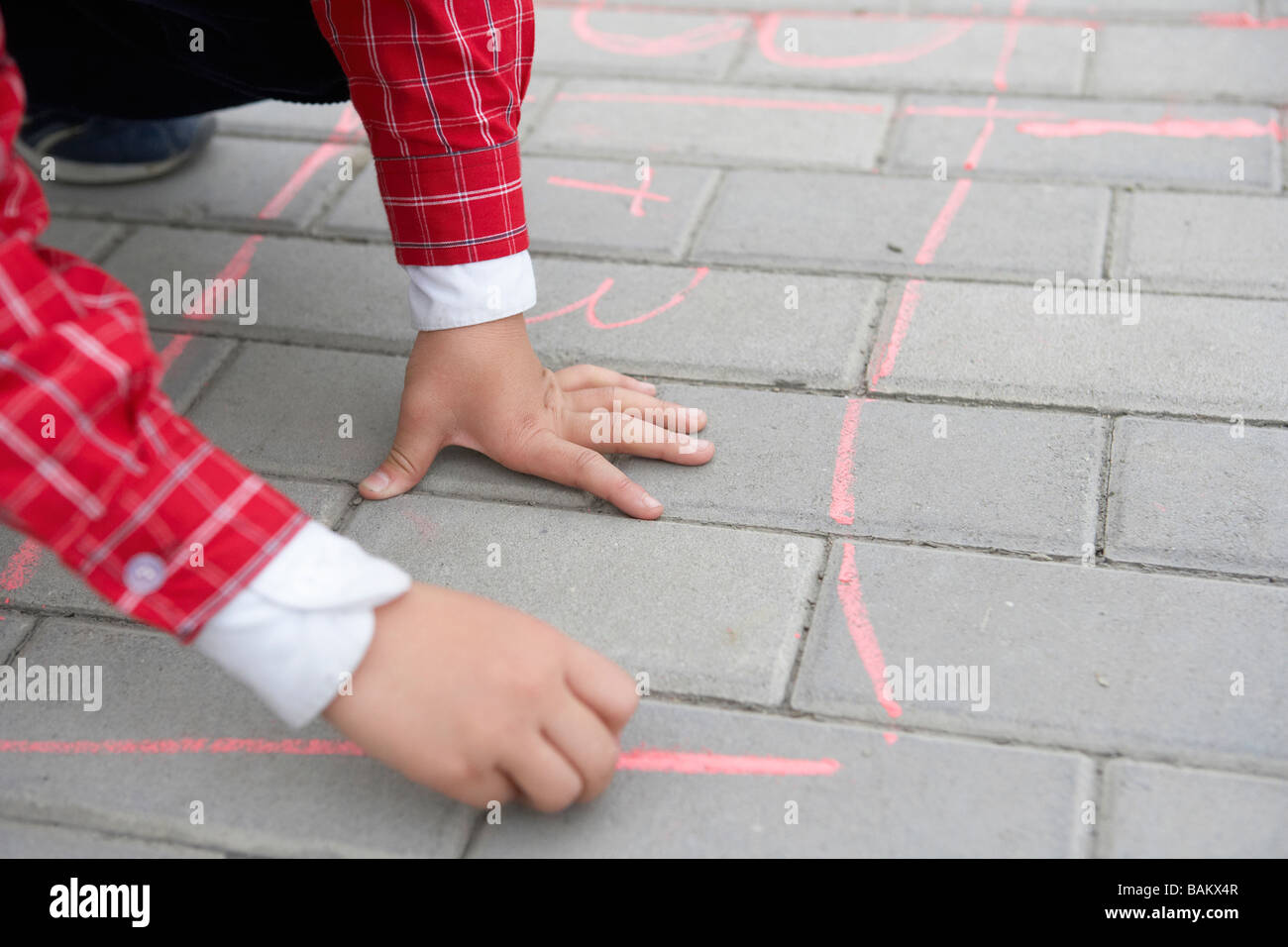 Boy Drawing On Sidewalk With Chalk Stock Photo - Alamy