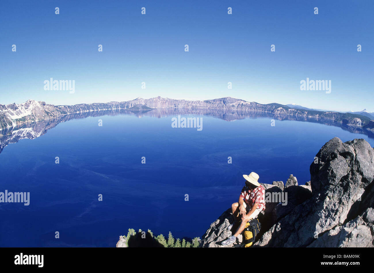 Hiker by crater lake Stock Photo