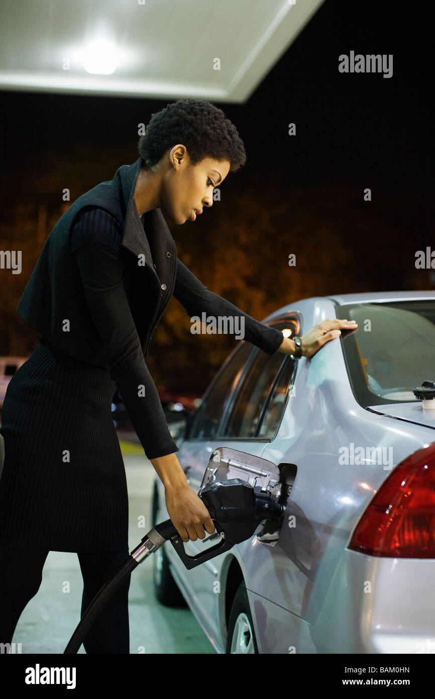 Woman at gas station Stock Photo