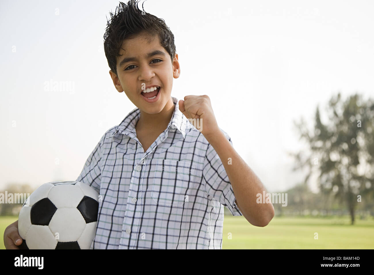 Portrait of a boy holding a football Stock Photo