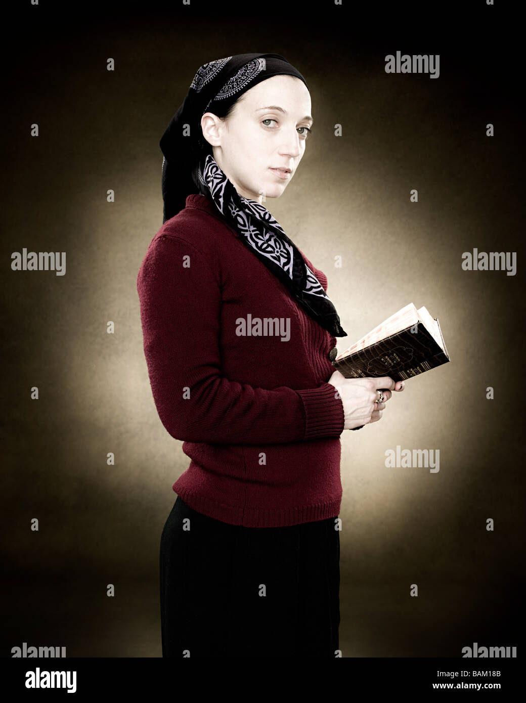 Portrait of a young jewish woman holding a prayer book Stock Photo