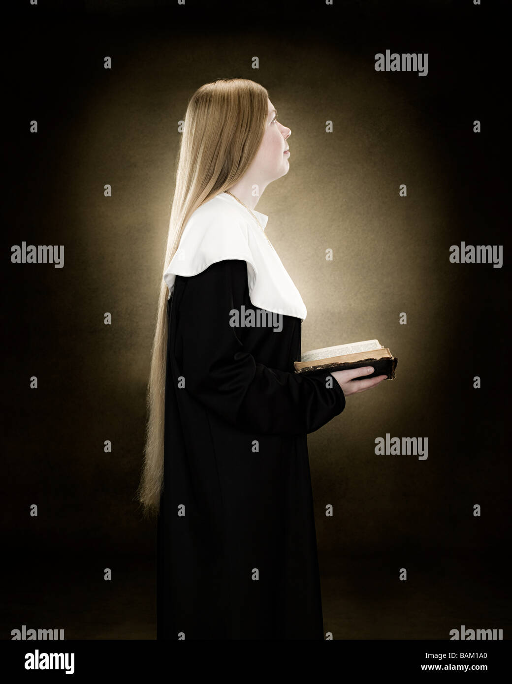 Profile of a nun praying Stock Photo