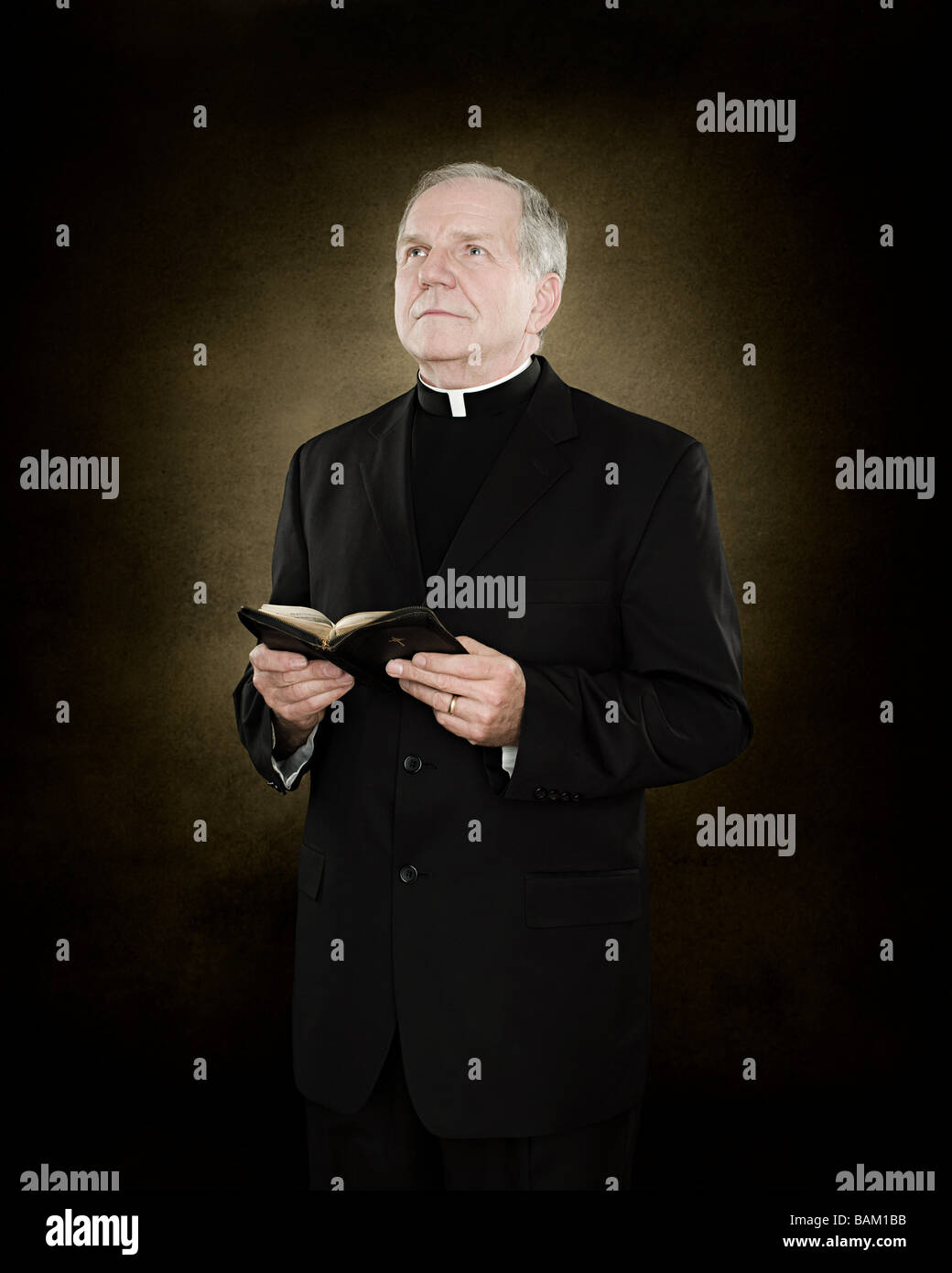 Portrait of a priest holding a bible Stock Photo