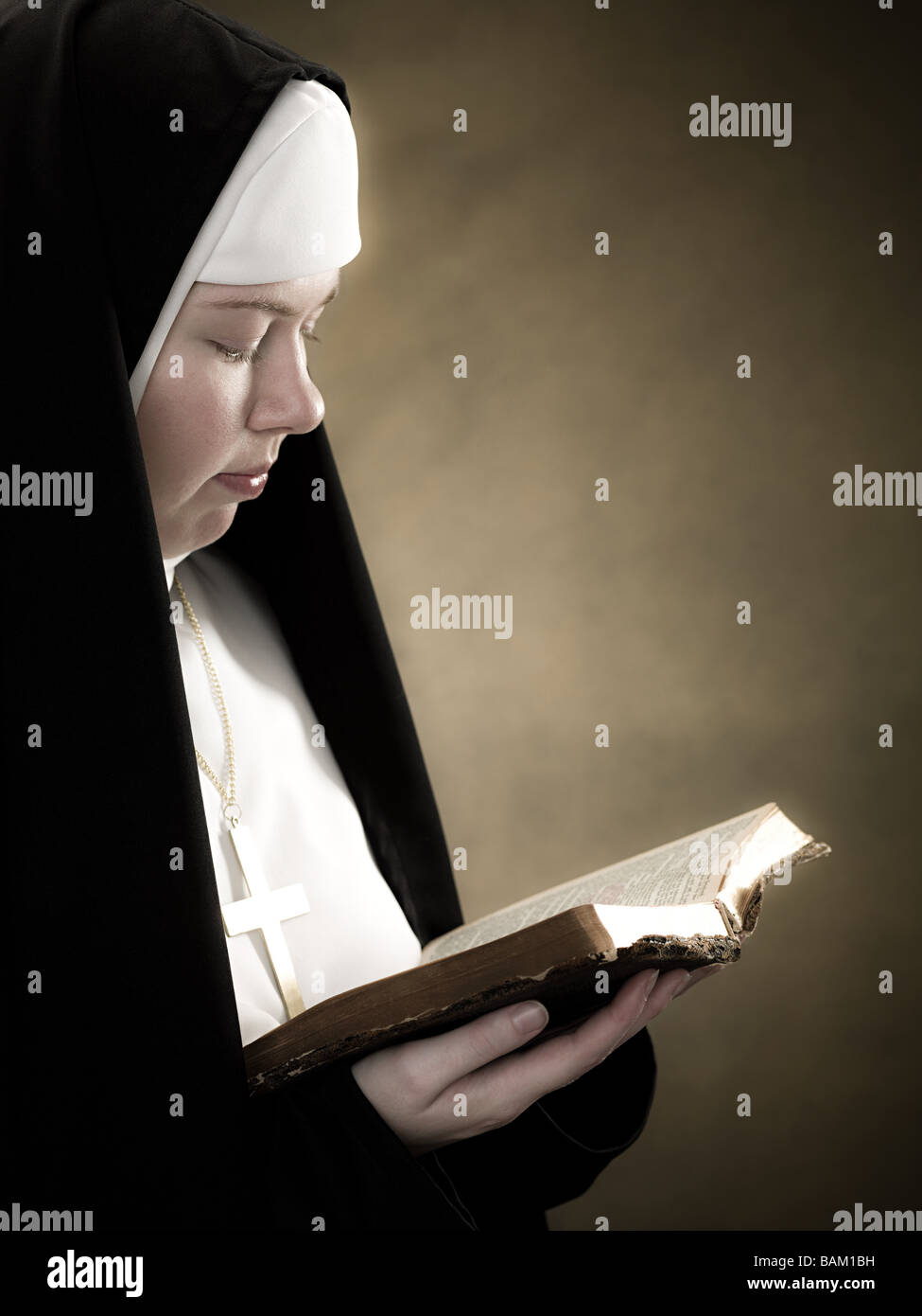 A nun reading a bible Stock Photo