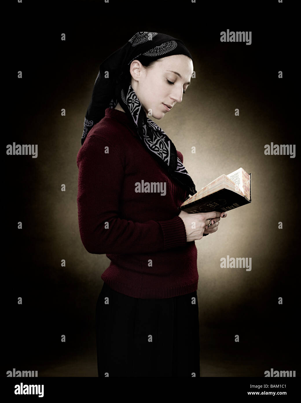 A young jewish woman reading a prayer book Stock Photo