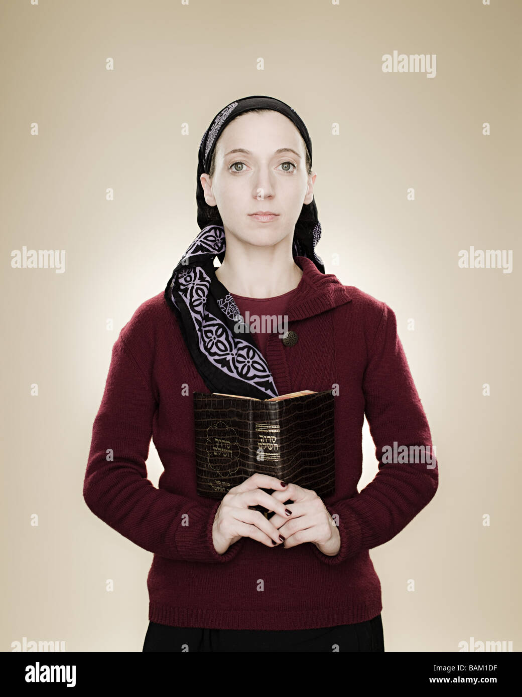 Portrait of a young jewish woman holding a prayer book Stock Photo