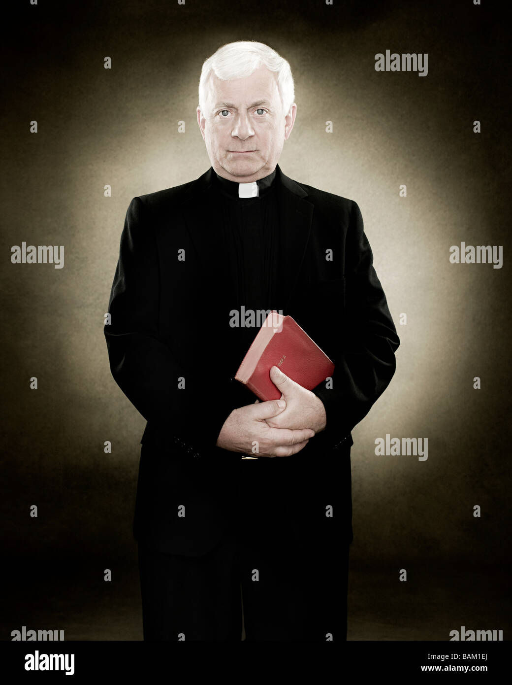 Portrait of a priest holding a bible Stock Photo