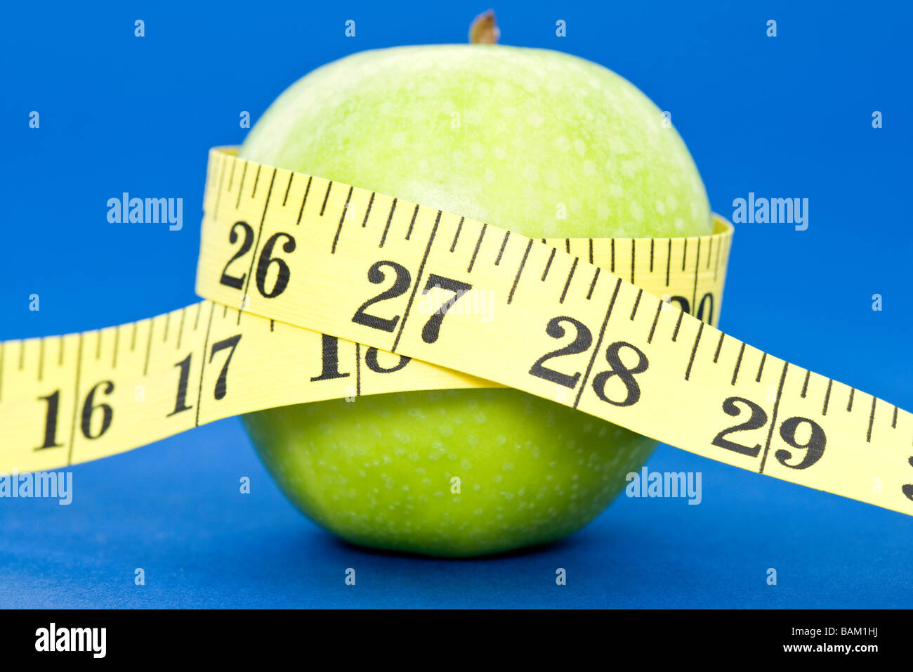 A tape measure wrapped around an apple Stock Photo