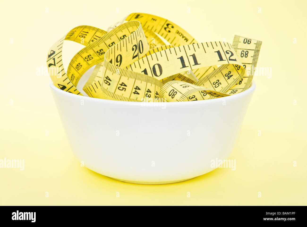 A tape measure in a bowl Stock Photo
