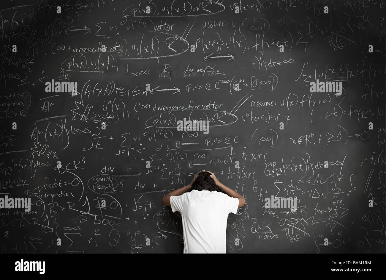 Boy with formulae on blackboard Stock Photo