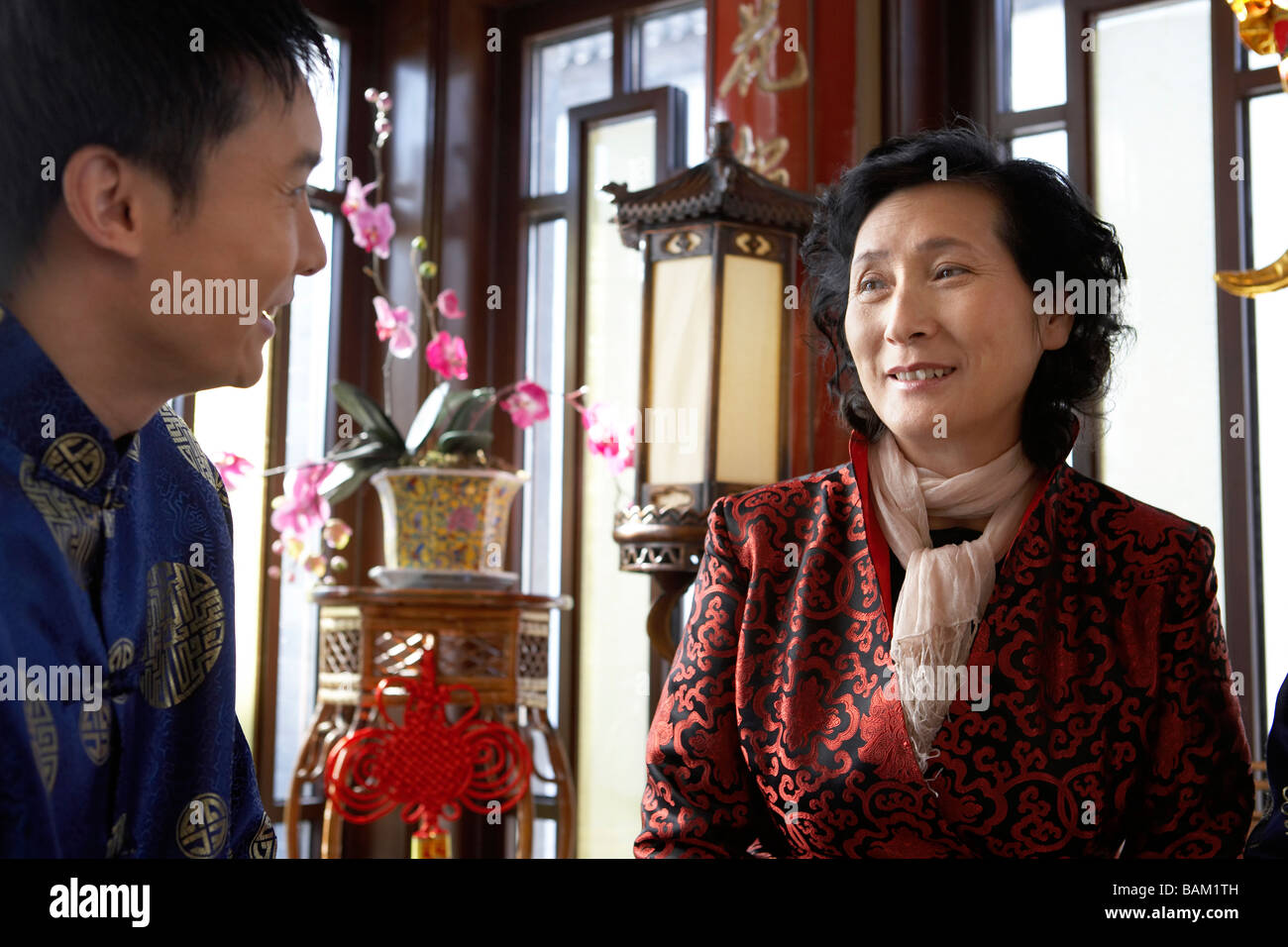 Traditionally Dressed Man And Senior Woman Speaking Stock Photo
