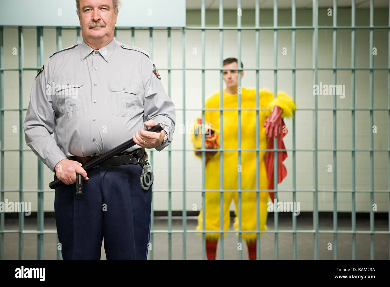 Guard and prisoner in chicken suit Stock Photo
