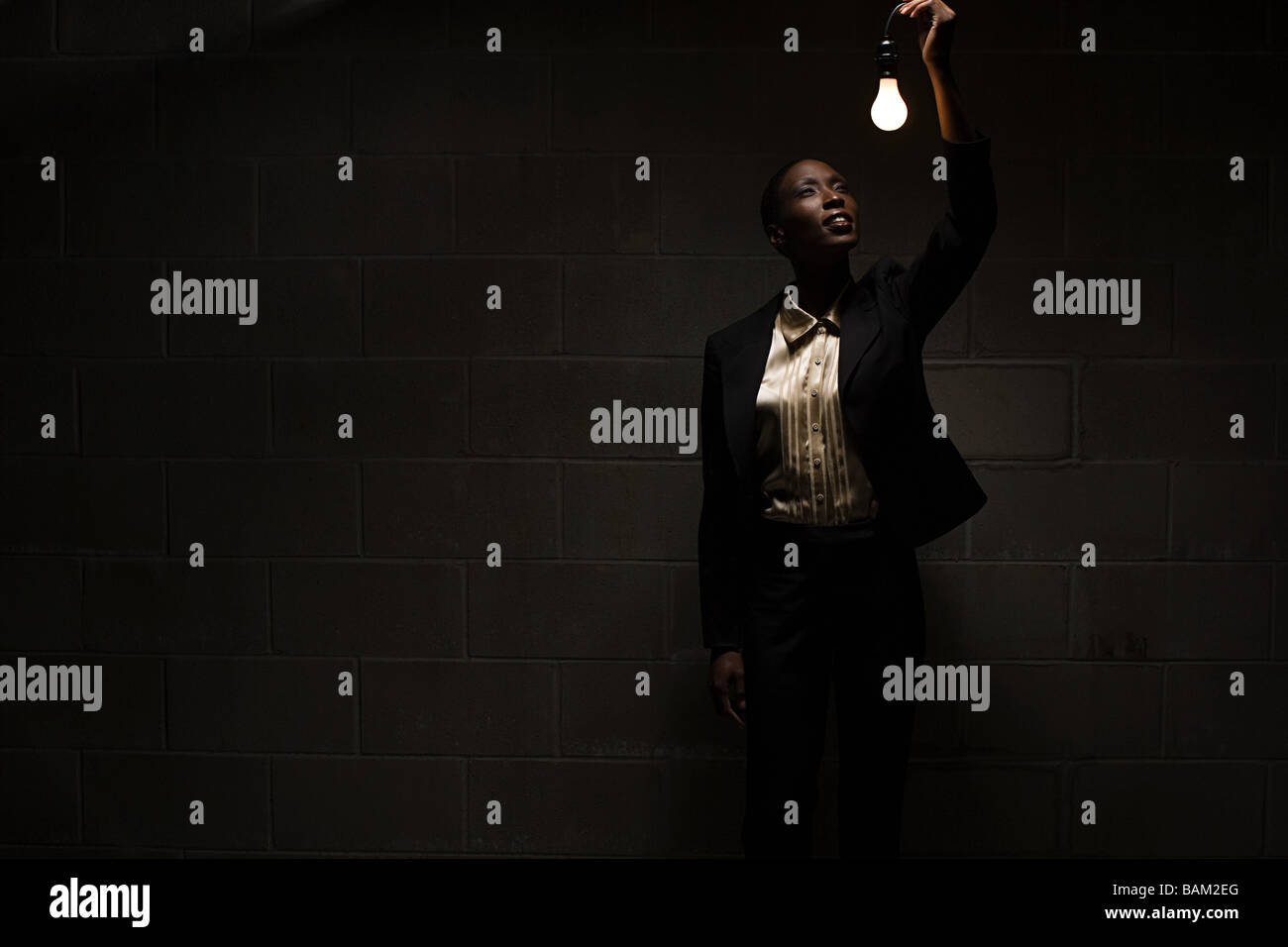 Businesswoman holding lightbulb Stock Photo