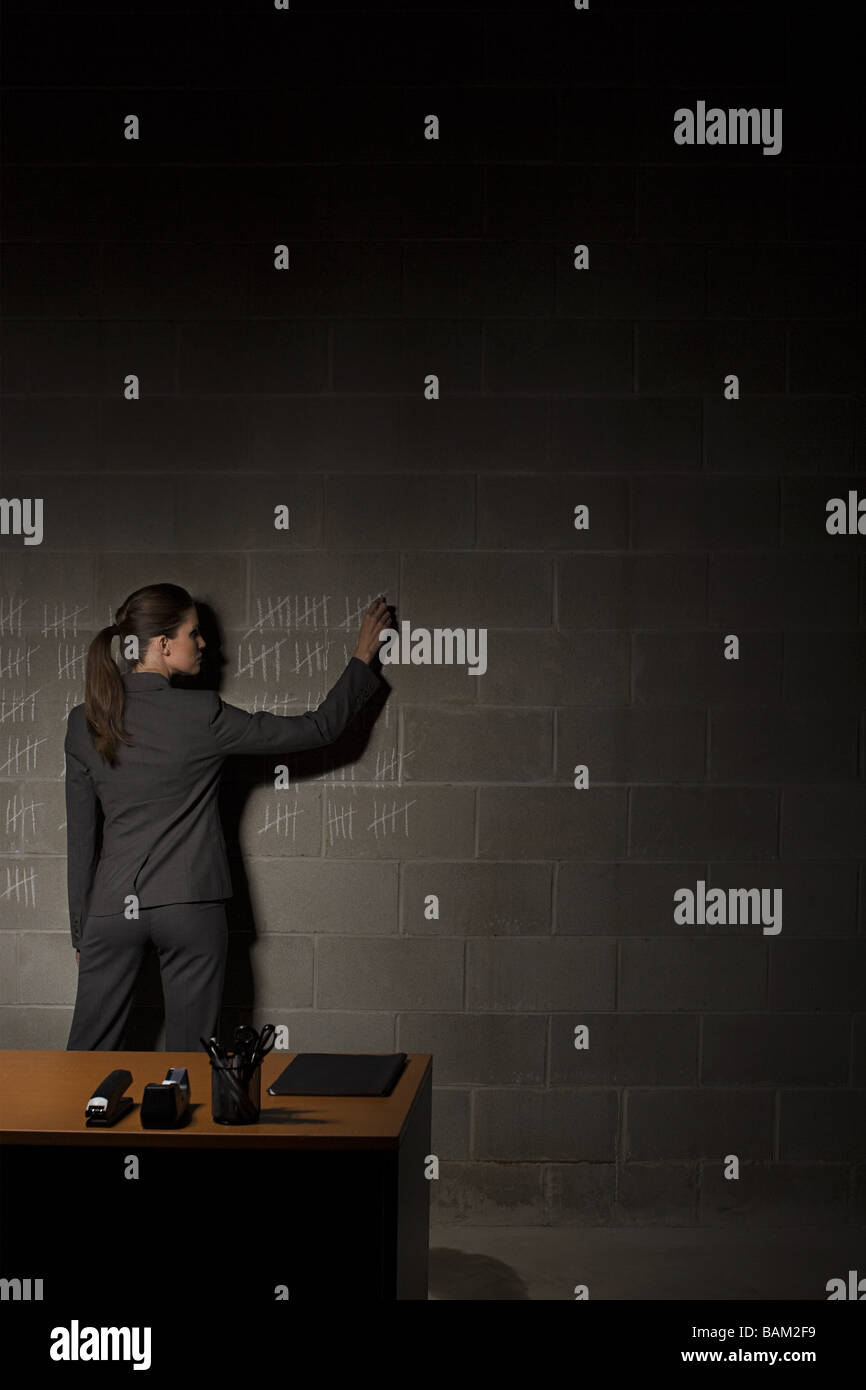 Businesswoman and chalk marks on wall Stock Photo