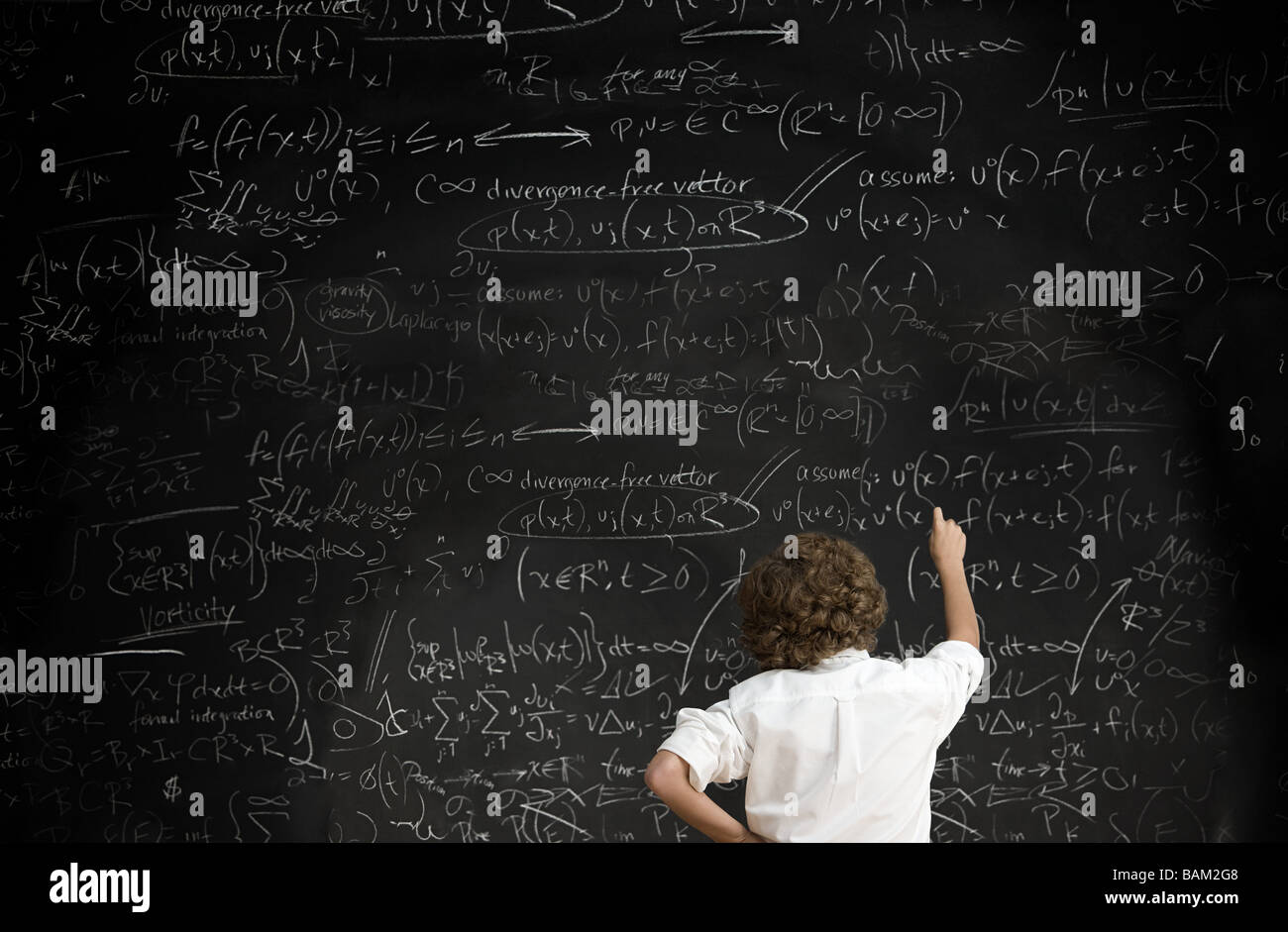 Boy with formulae on blackboard Stock Photo