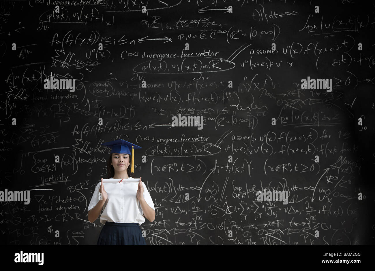 Graduating girl in front of blackboard Stock Photo