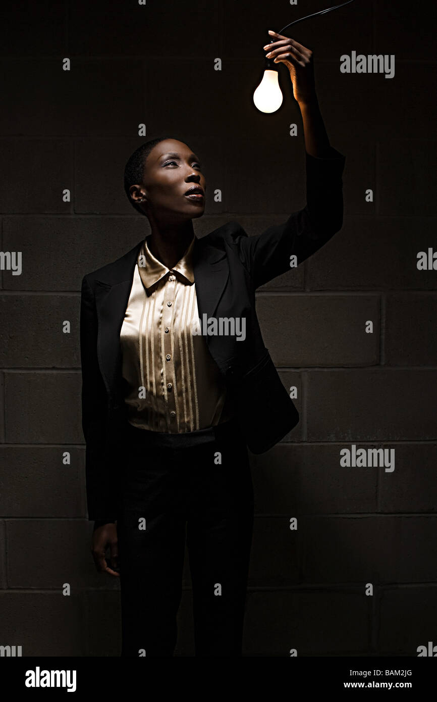 Businesswoman holding lightbulb Stock Photo