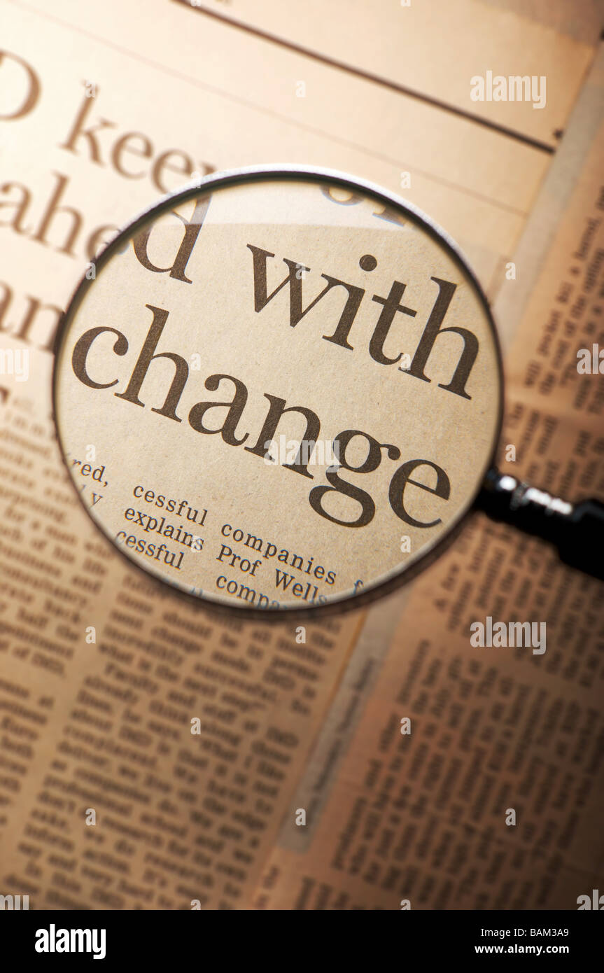 Word change under magnifying glass Stock Photo