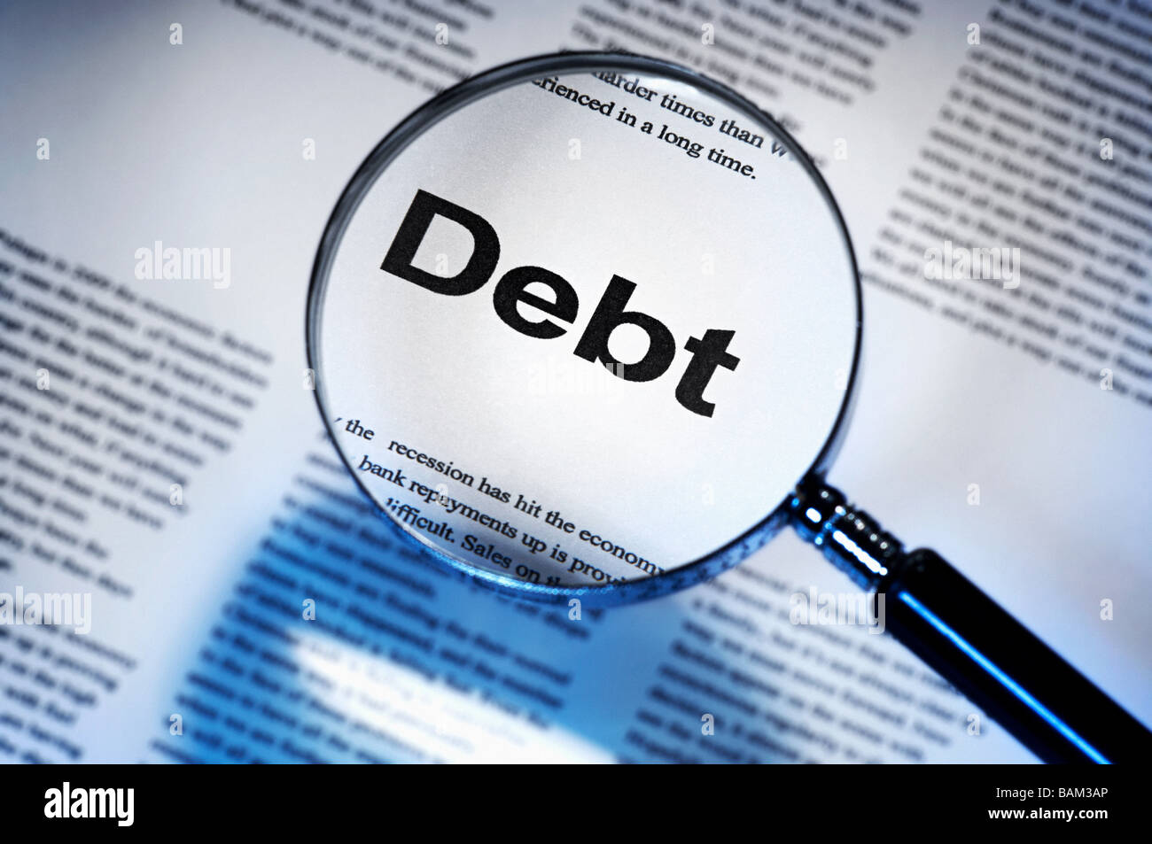 Word debt under magnifying glass Stock Photo - Alamy