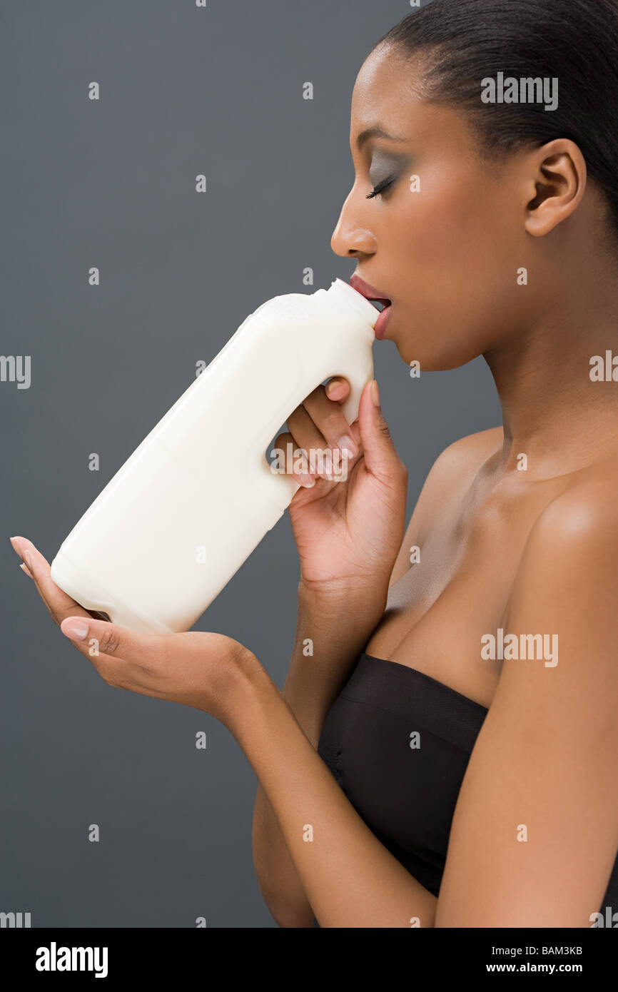 Woman drinking a bottle of milk Stock Photo