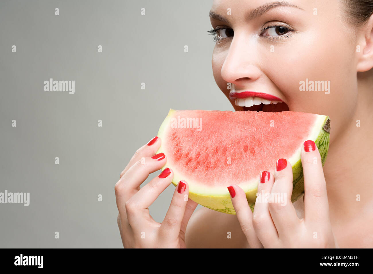 Young woman eating watermelon Stock Photo
