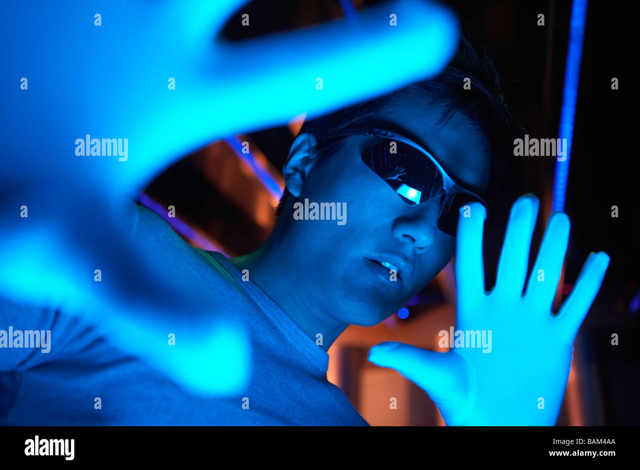 Close-Up Of Futuristic Looking Man Wearing Sunglasses Stock Photo