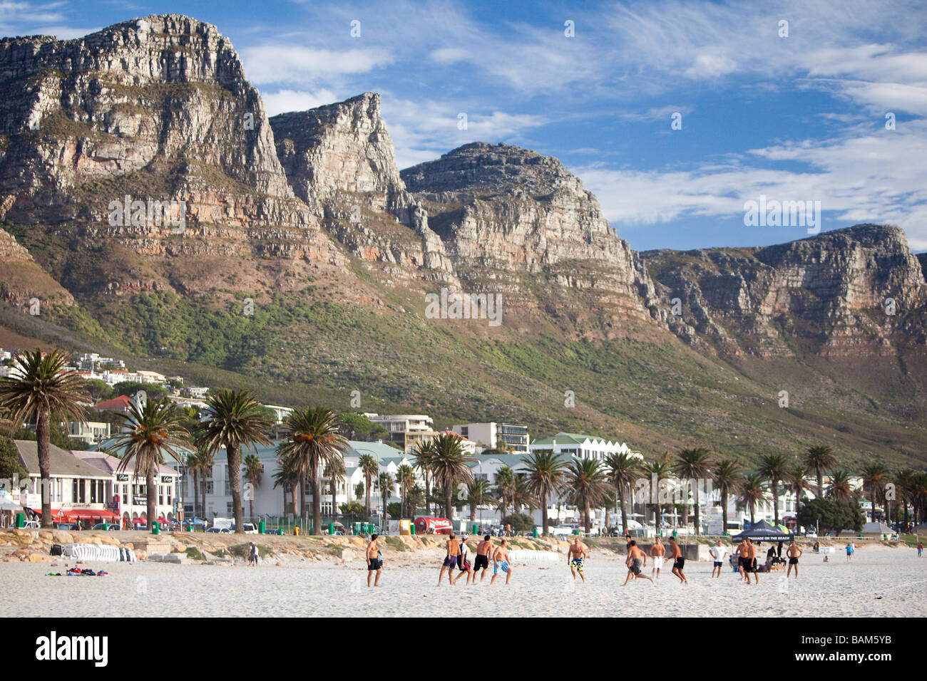 Playing football on Camps Bay beach, Cape Town, South Africa Stock Photo