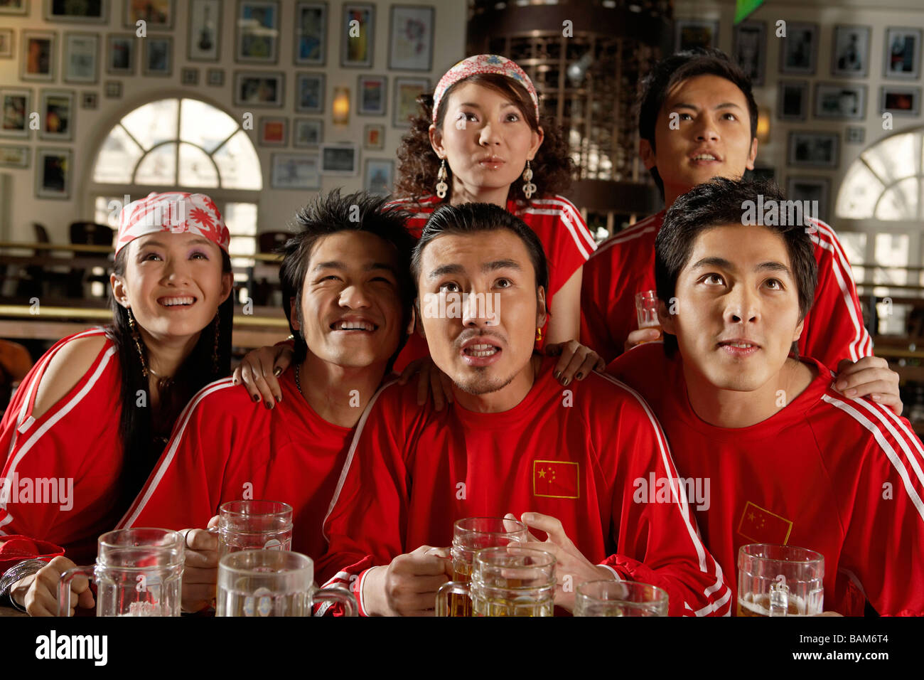 Sport Enthusiasts Watching Game In Sports Bar Stock Photo