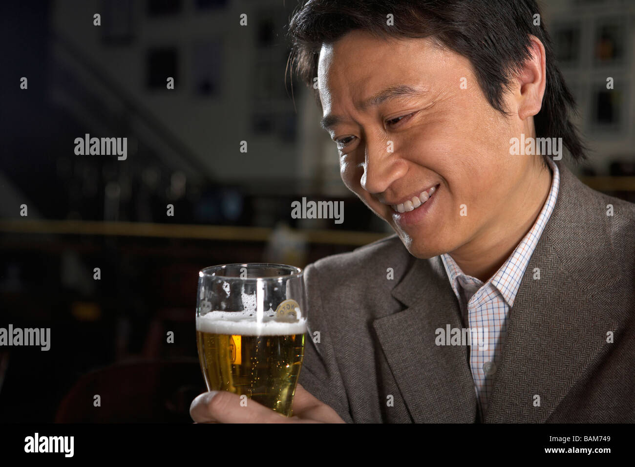 Happy Businessman Holding Beer Stock Photo