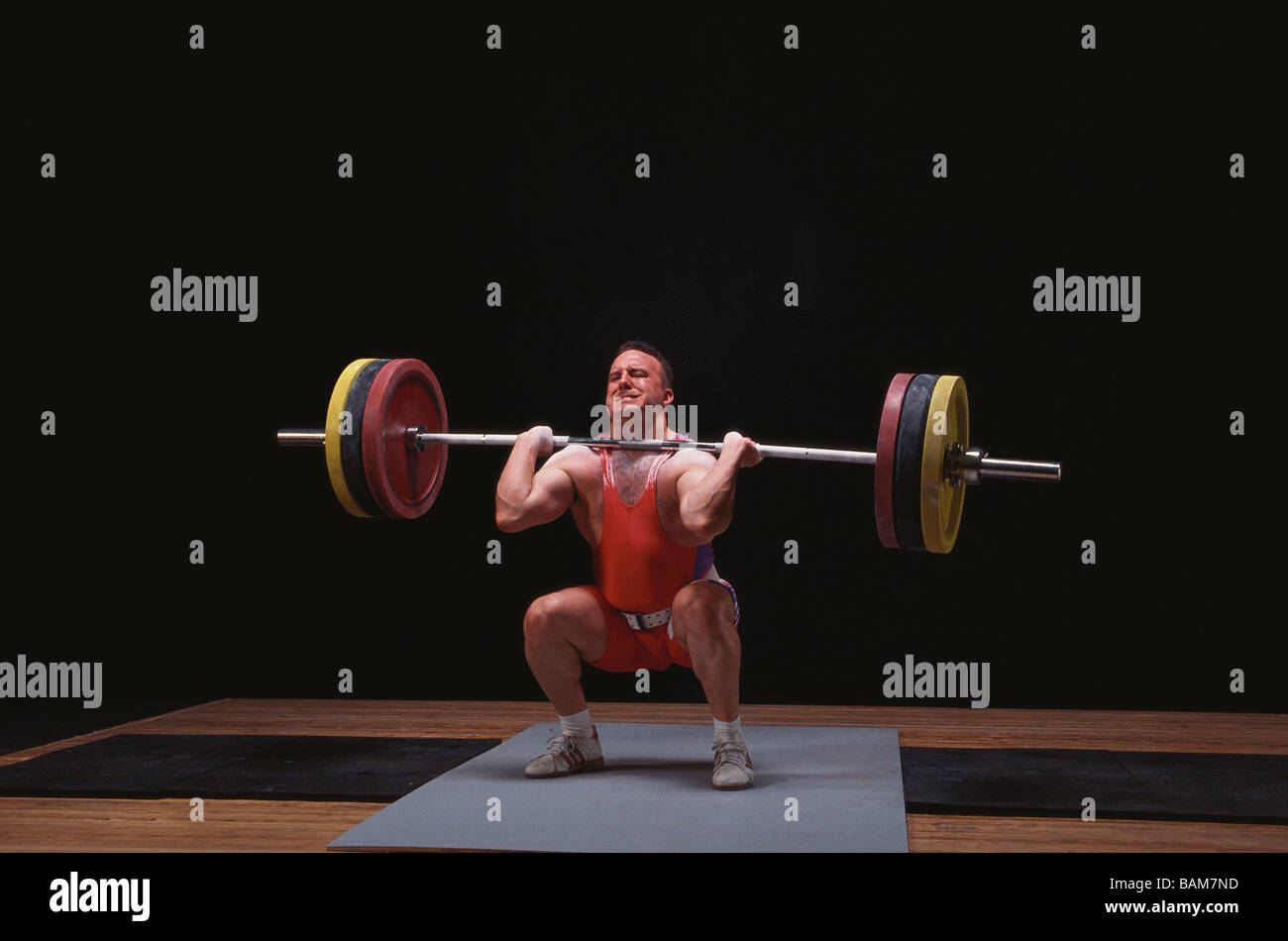 Olympic style weightlifter in action Stock Photo
