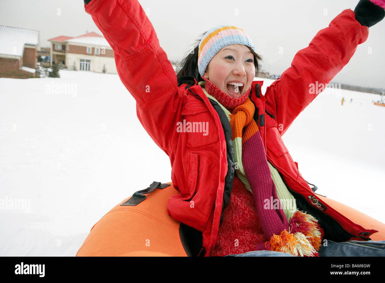 Mother Riding On Inflatable Snow Tube Stock Photo Alamy