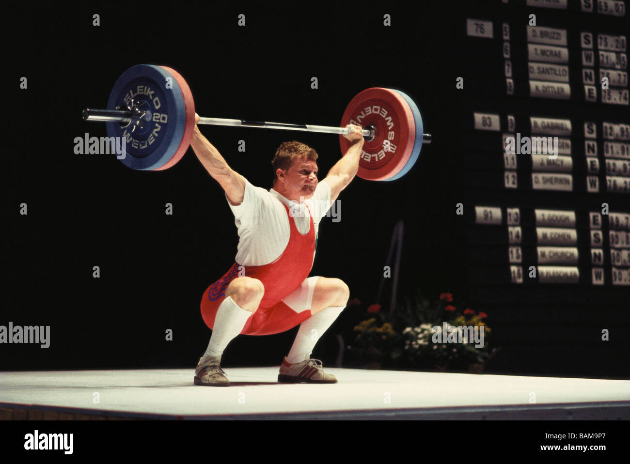 Olympic style weightlifter in action Stock Photo