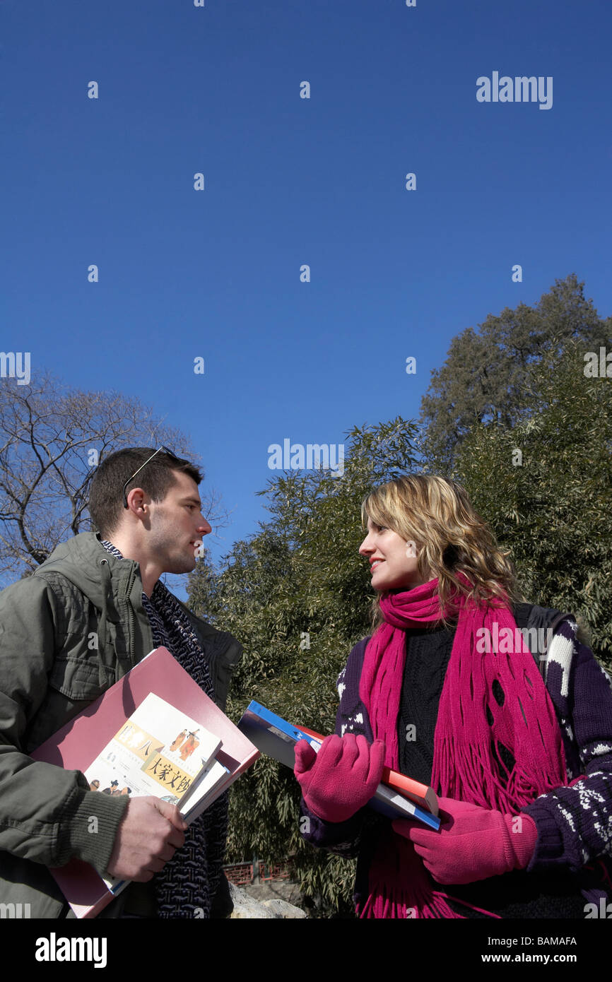 Young People Carrying Books Stock Photo