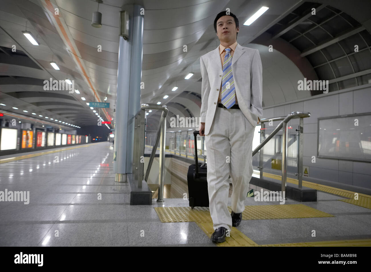 Man Walking With Suitcase In Train Station Stock Photo Alamy