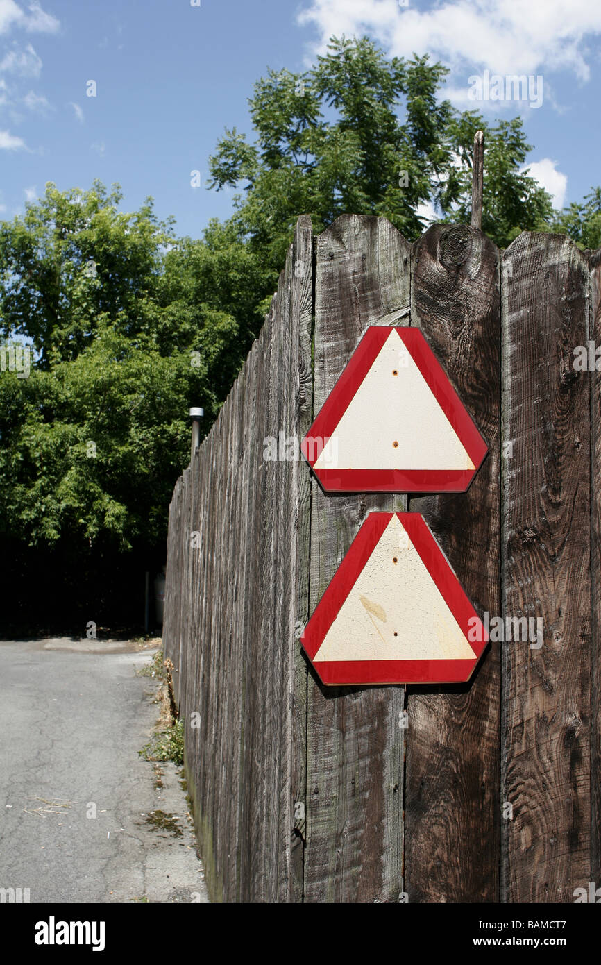 Road warning signs on a fence Stock Photo