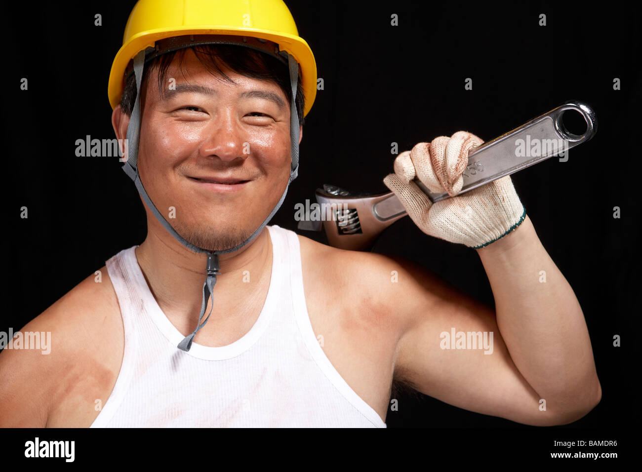 Man Wearing A Hard Hat Holding A Spanner Stock Photo - Alamy