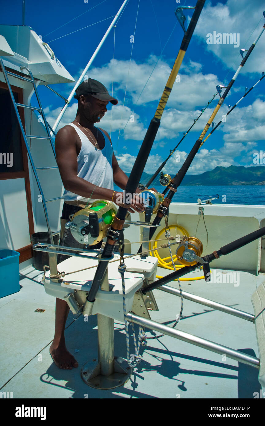 Fisherman with fishing rod big game fishing on boat Mauritius