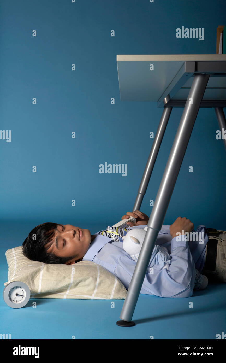 Man Sleeping Under His Desk Stock Photo Alamy